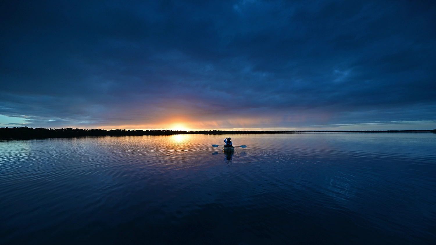 boat on quiet lake at night