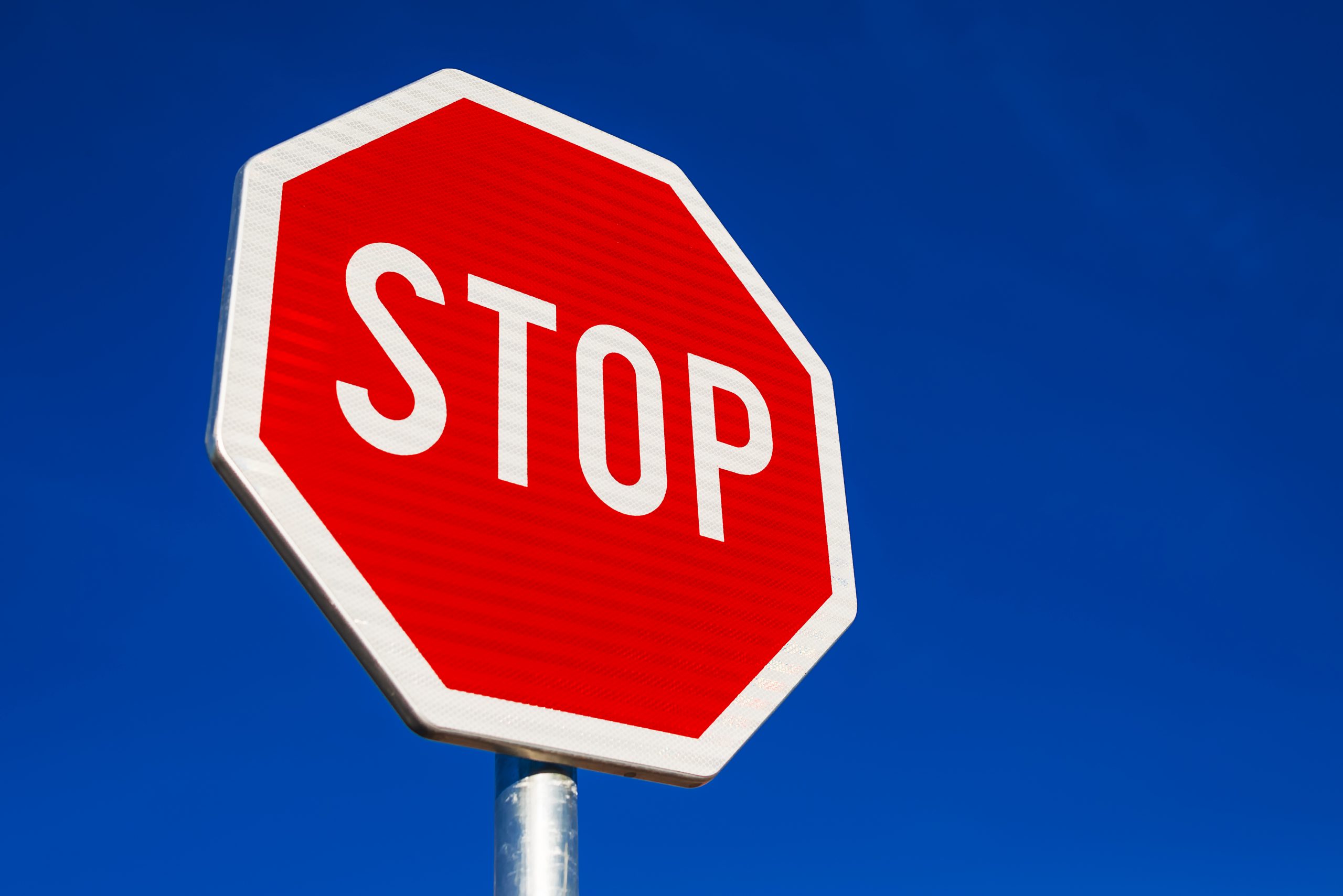 picture of clean stop sign with blue sky